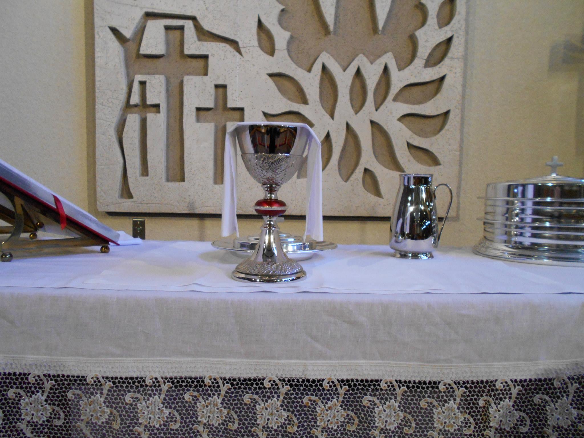 silver chalis on altar